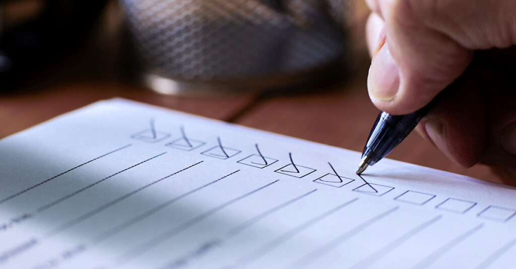 Image of a person checking boxes on an application form