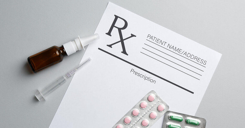 An image depicting a blank Rx form along with various prescription medications